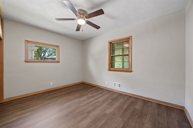 spare room with wood finished floors, baseboards, and a ceiling fan