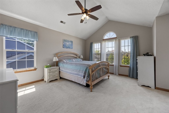 bedroom with baseboards, vaulted ceiling, light colored carpet, and ceiling fan