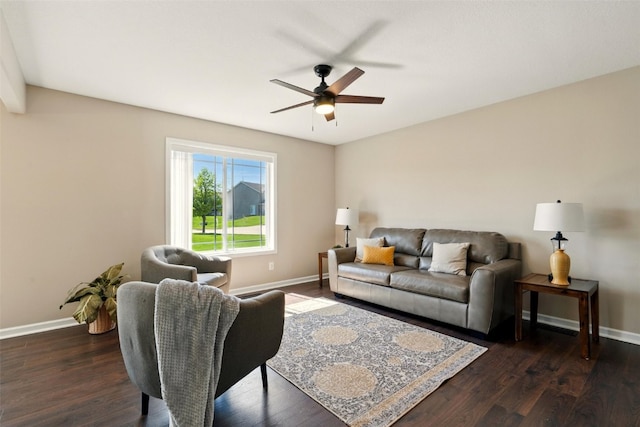 living room featuring baseboards, ceiling fan, and dark wood-style flooring