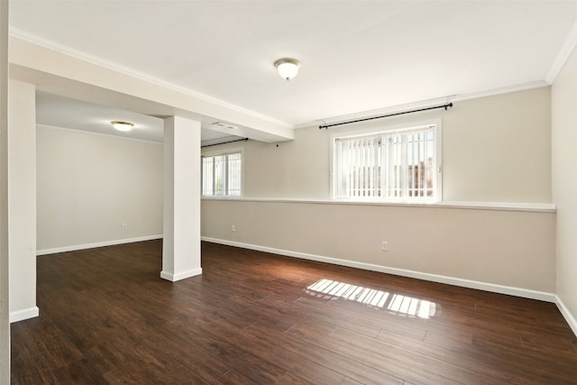 below grade area featuring ornamental molding, baseboards, and wood finished floors