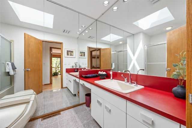 13 Woodland Hts, Iowa City, IA 52240 - full bath featuring a skylight, an enclosed shower, vanity, recessed lighting, and granite tiled floors