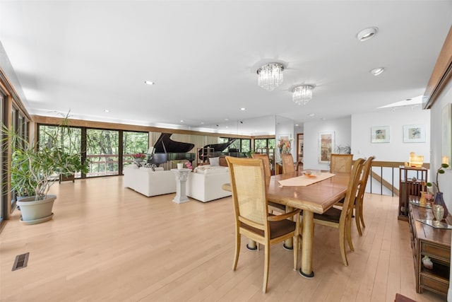 13 Woodland Hts, Iowa City, IA 52240 - dining room with light wood finished floors, a chandelier, and recessed lighting