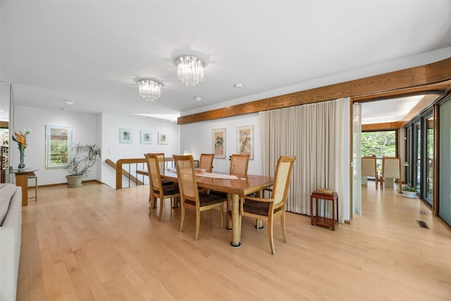 13 Woodland Hts, Iowa City, IA 52240 - dining space featuring a chandelier, light wood-style floors, and plenty of natural light