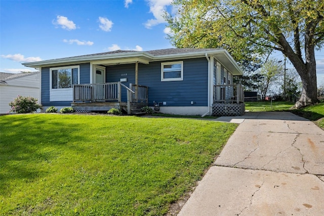 bungalow with covered porch, a front yard, and driveway