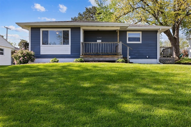 rear view of property featuring a yard