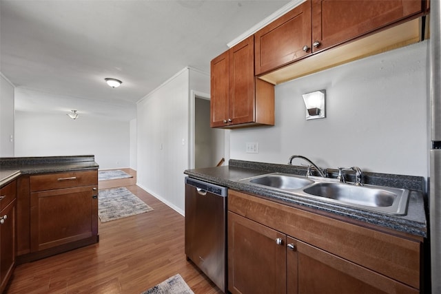 kitchen with stainless steel dishwasher, dark countertops, dark wood finished floors, a sink, and brown cabinets