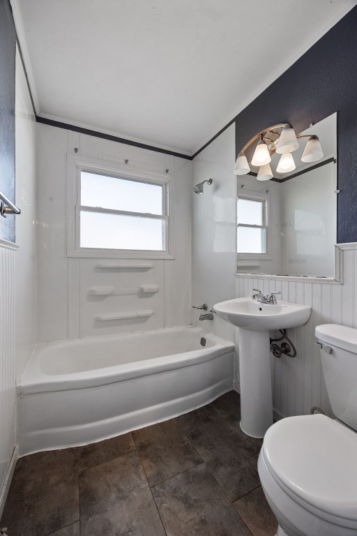 full bathroom featuring toilet, shower / washtub combination, crown molding, and a sink