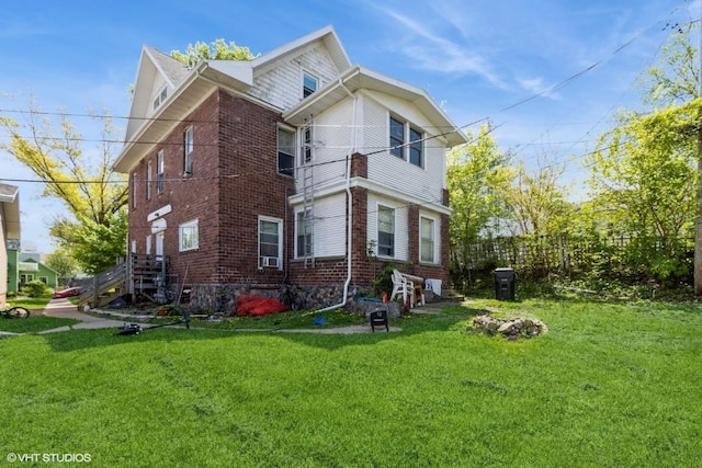 back of property with brick siding and a lawn