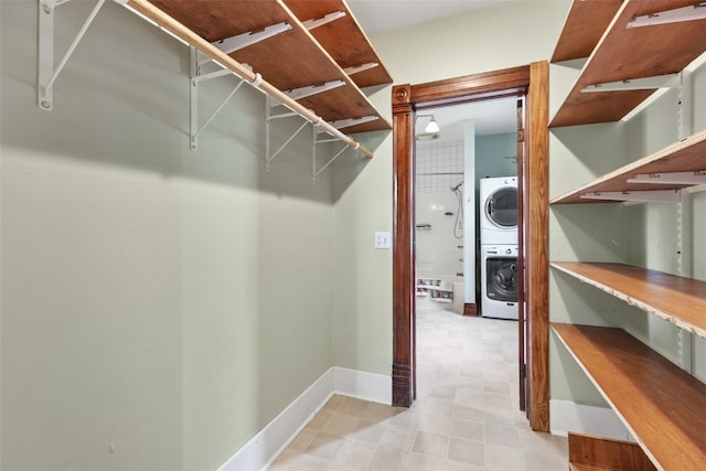 walk in closet featuring estacked washer and dryer