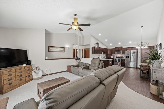 living area featuring lofted ceiling, ceiling fan, recessed lighting, dark wood-type flooring, and a chandelier