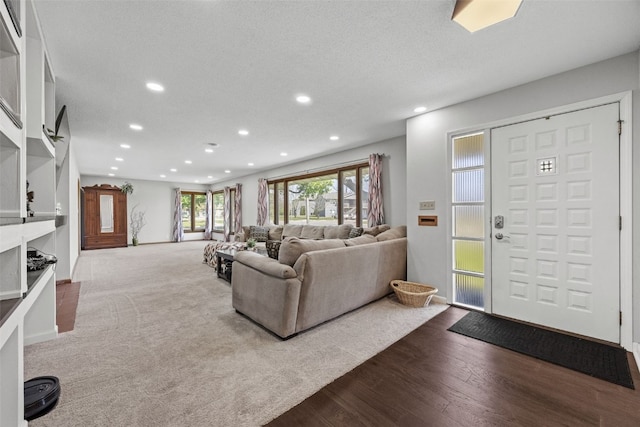 living room with recessed lighting and dark wood-type flooring