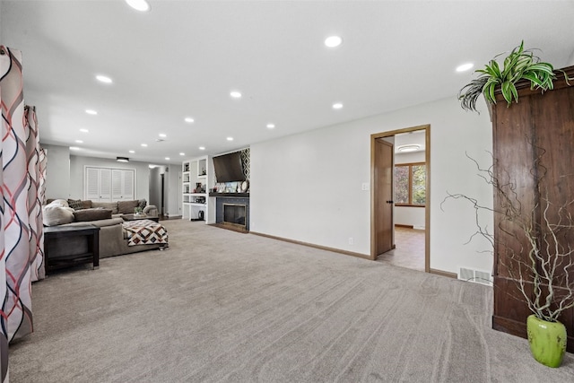 living room featuring light carpet, recessed lighting, a fireplace, and baseboards