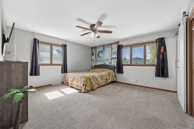 carpeted bedroom with baseboards and a ceiling fan