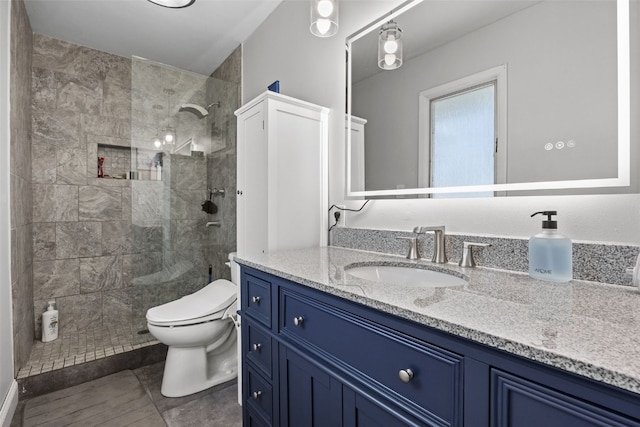 full bath featuring a walk in shower, vanity, toilet, and tile patterned floors