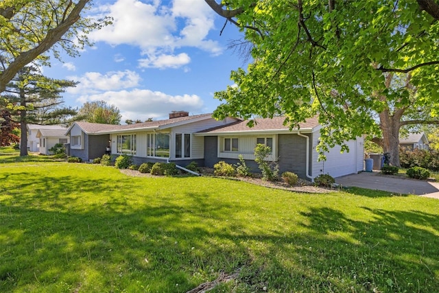 ranch-style home with an attached garage, driveway, a front lawn, and a chimney