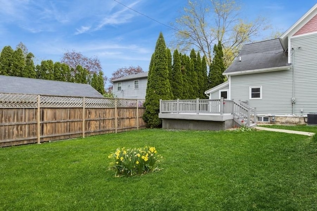 view of yard with a wooden deck and central AC unit
