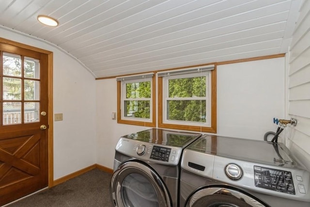 washroom featuring washing machine and clothes dryer, carpet, and baseboards