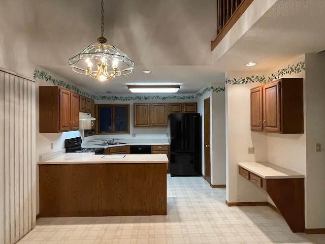 kitchen with black appliances, light floors, light countertops, and under cabinet range hood