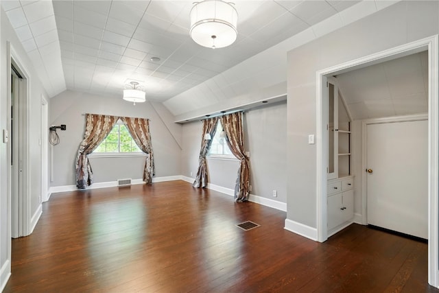 additional living space with vaulted ceiling, hardwood / wood-style floors, and baseboards