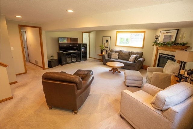 living area with a tile fireplace, light carpet, baseboards, and recessed lighting