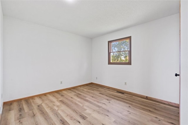 6119 28th Ave Dr, Vinton, IA 52349 - empty room with wood finished floors and baseboards