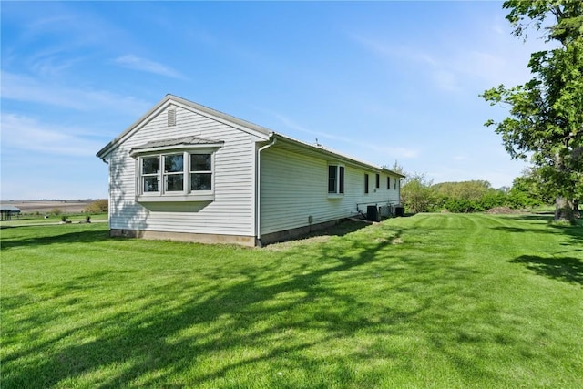 6119 28th Ave Dr, Vinton, IA 52349 - view of home's exterior featuring a lawn and central AC