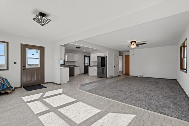 6119 28th Ave Dr, Vinton, IA 52349 - unfurnished living room with ceiling fan and baseboards
