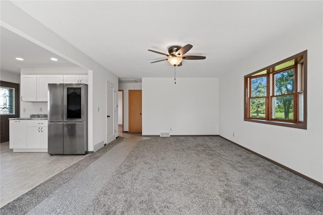 6119 28th Ave Dr, Vinton, IA 52349 - unfurnished living room with baseboards, a ceiling fan, light carpet, and recessed lighting