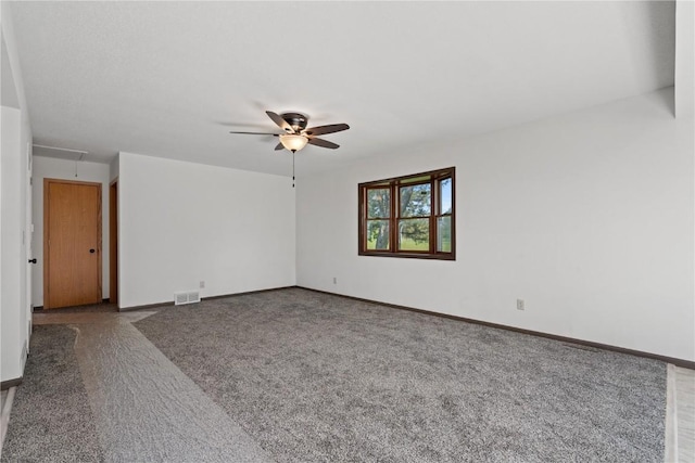 6119 28th Ave Dr, Vinton, IA 52349 - carpeted empty room with attic access, a ceiling fan, and baseboards