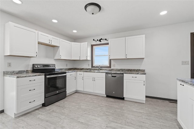 6119 28th Ave Dr, Vinton, IA 52349 - kitchen featuring appliances with stainless steel finishes, white cabinets, recessed lighting, and baseboards