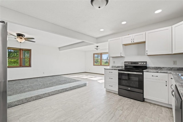 6119 28th Ave Dr, Vinton, IA 52349 - kitchen with appliances with stainless steel finishes, plenty of natural light, open floor plan, white cabinetry, and recessed lighting