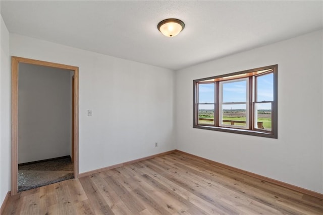 6119 28th Ave Dr, Vinton, IA 52349 - empty room with light wood finished floors and baseboards