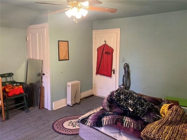 carpeted bedroom with radiator, a ceiling fan, and vaulted ceiling