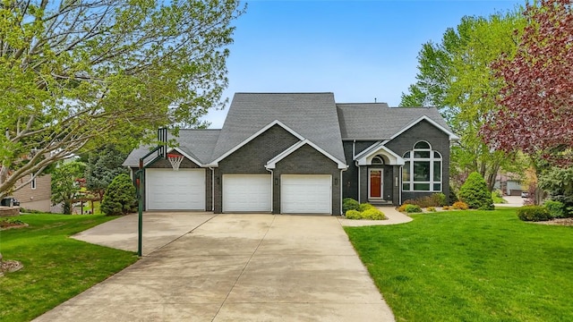 1659 Apache Dr NE, Solon, IA 52333 - view of front of property featuring a front lawn, an attached garage, concrete driveway, and a shingled roof