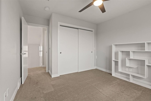 1659 Apache Dr NE, Solon, IA 52333 - unfurnished bedroom featuring carpet, a closet, ceiling fan, and baseboards