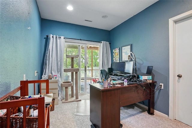 office with carpet floors, a textured wall, and baseboards