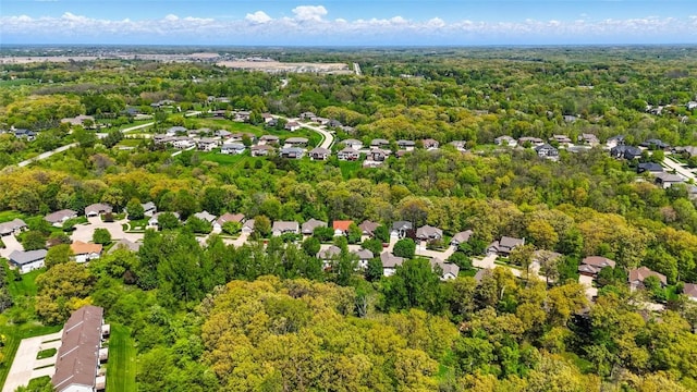 aerial perspective of suburban area with a heavily wooded area
