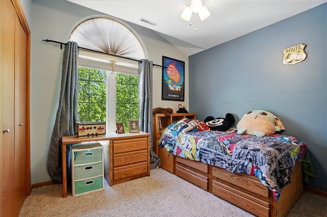 carpeted bedroom featuring vaulted ceiling and ceiling fan