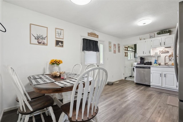 906 W 18th St, Vinton, IA 52349 - dining space featuring light wood-type flooring and baseboards