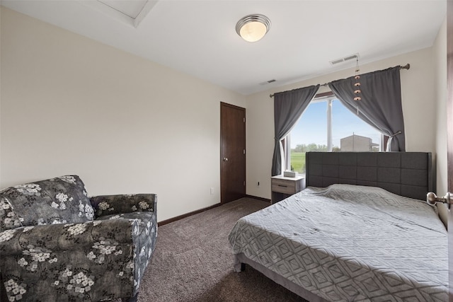 carpeted bedroom with baseboards and attic access