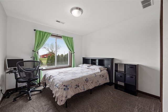 bedroom featuring dark carpet and baseboards