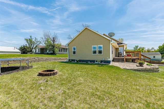 1100 Vernon Hill Blvd, Cedar Rapids, IA 52403 - back of house featuring a fire pit, a wooden deck, and a yard