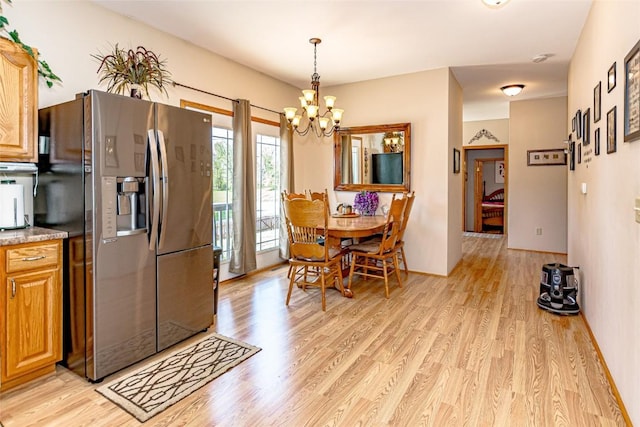 1100 Vernon Hill Blvd, Cedar Rapids, IA 52403 - dining room with a chandelier and light wood finished floors