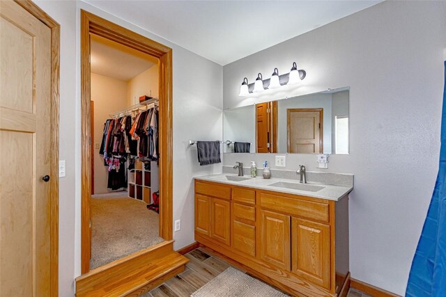1100 Vernon Hill Blvd, Cedar Rapids, IA 52403 - full bath with wood finished floors, double vanity, baseboards, and a spacious closet