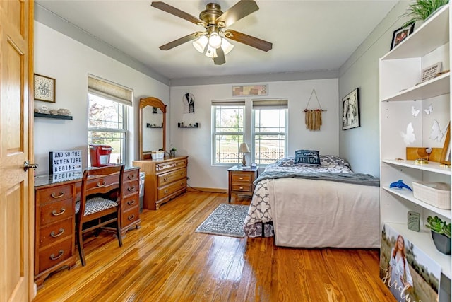1100 Vernon Hill Blvd, Cedar Rapids, IA 52403 - bedroom featuring light wood-type flooring, multiple windows, and a ceiling fan