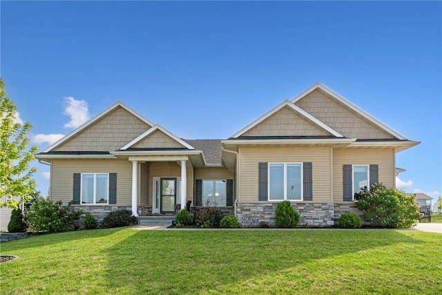 craftsman-style home featuring stone siding and a front lawn