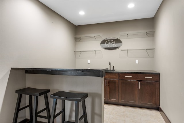 bar featuring recessed lighting and a sink
