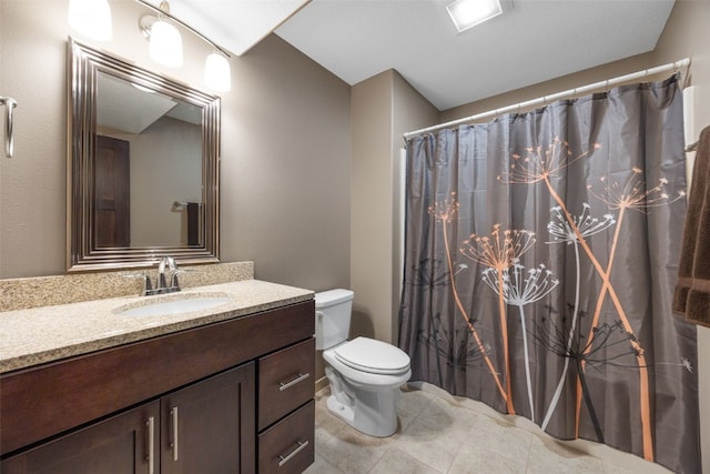 bathroom with toilet, vanity, tile patterned flooring, and a shower with shower curtain