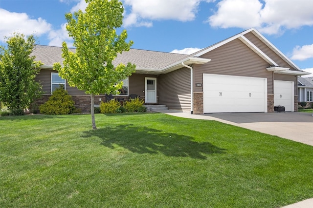 view of front facade featuring an attached garage, stone siding, driveway, a front lawn, and roof with shingles