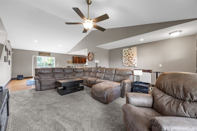 living area featuring lofted ceiling, ceiling fan, light colored carpet, recessed lighting, and baseboards